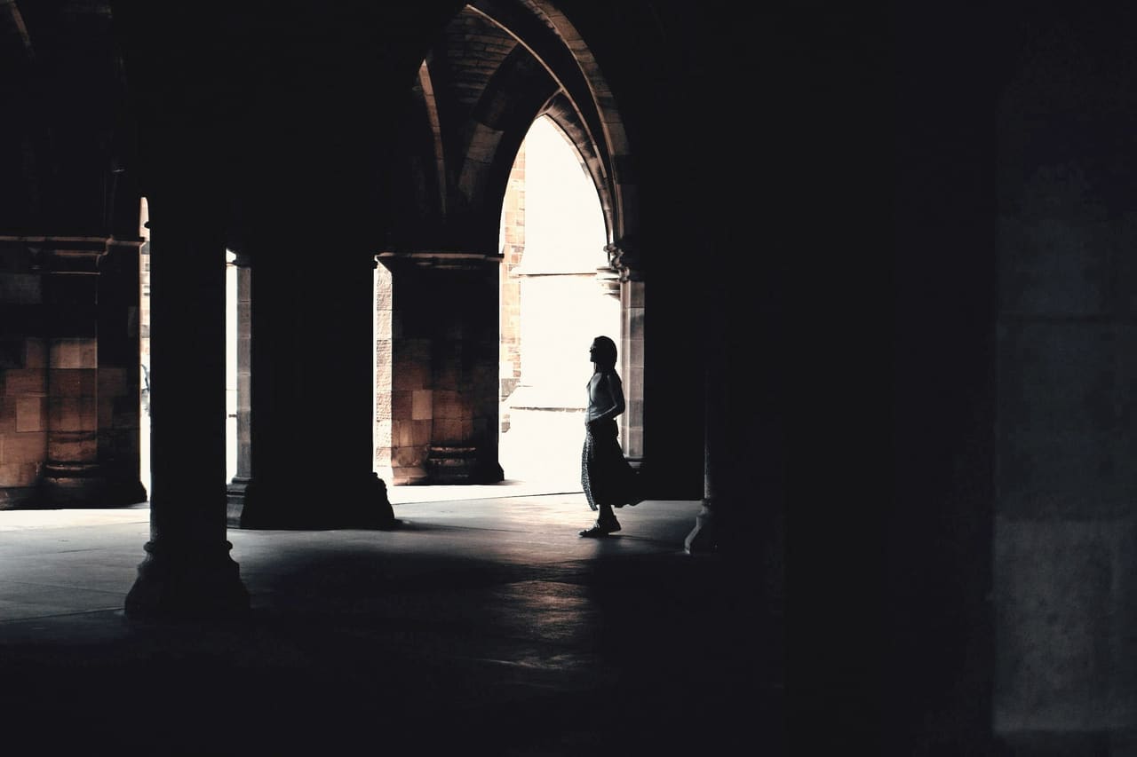 A silhouette in a colonnade