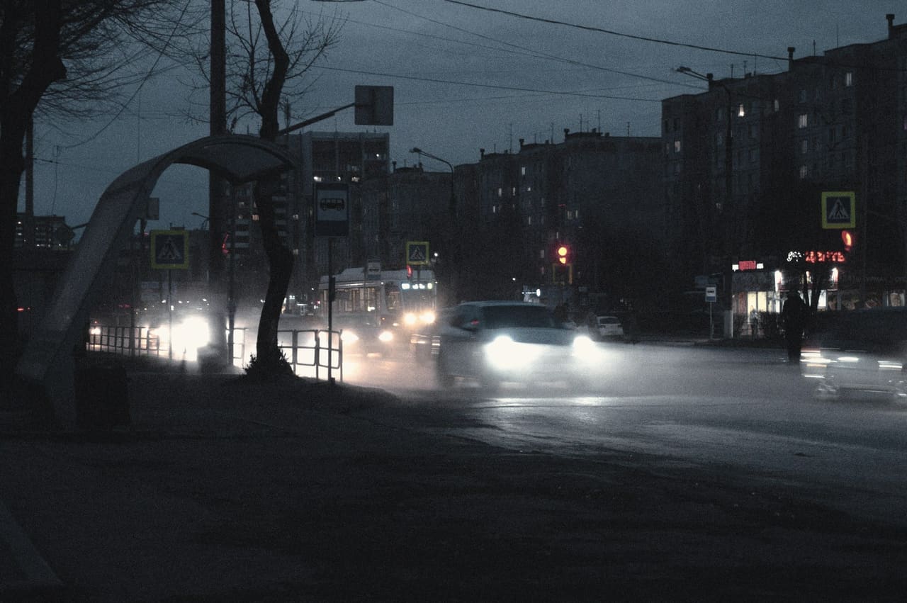 Headlights on a wet road at night
